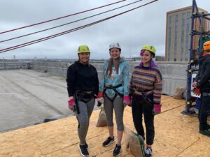 Danielle Pallett, Rebecca Beale and Megan Carthy on the roof of Millennium Point, preparing to abseil for Birmingham Children’s Hospital