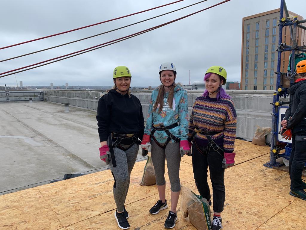 Danielle Pallett, Rebecca Beale and Megan Carthy on the roof of Millennium Point, preparing to abseil for Birmingham Children’s Hospital