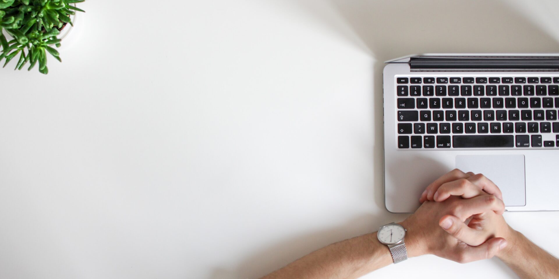 Top five video interview tips: Hands clasped together on top of open laptop